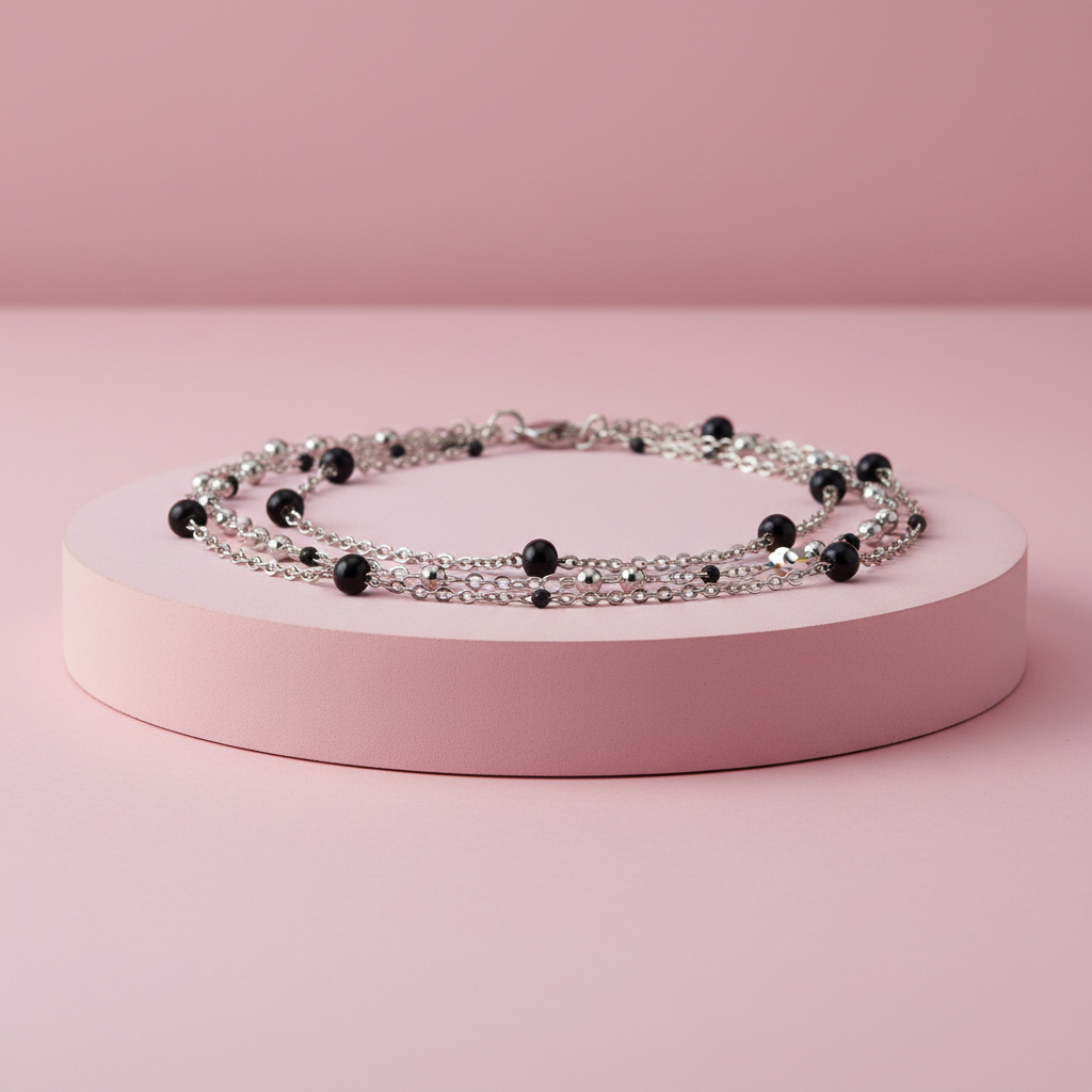 Collana multifilo sfere nere su piedistallo rosa cipria
