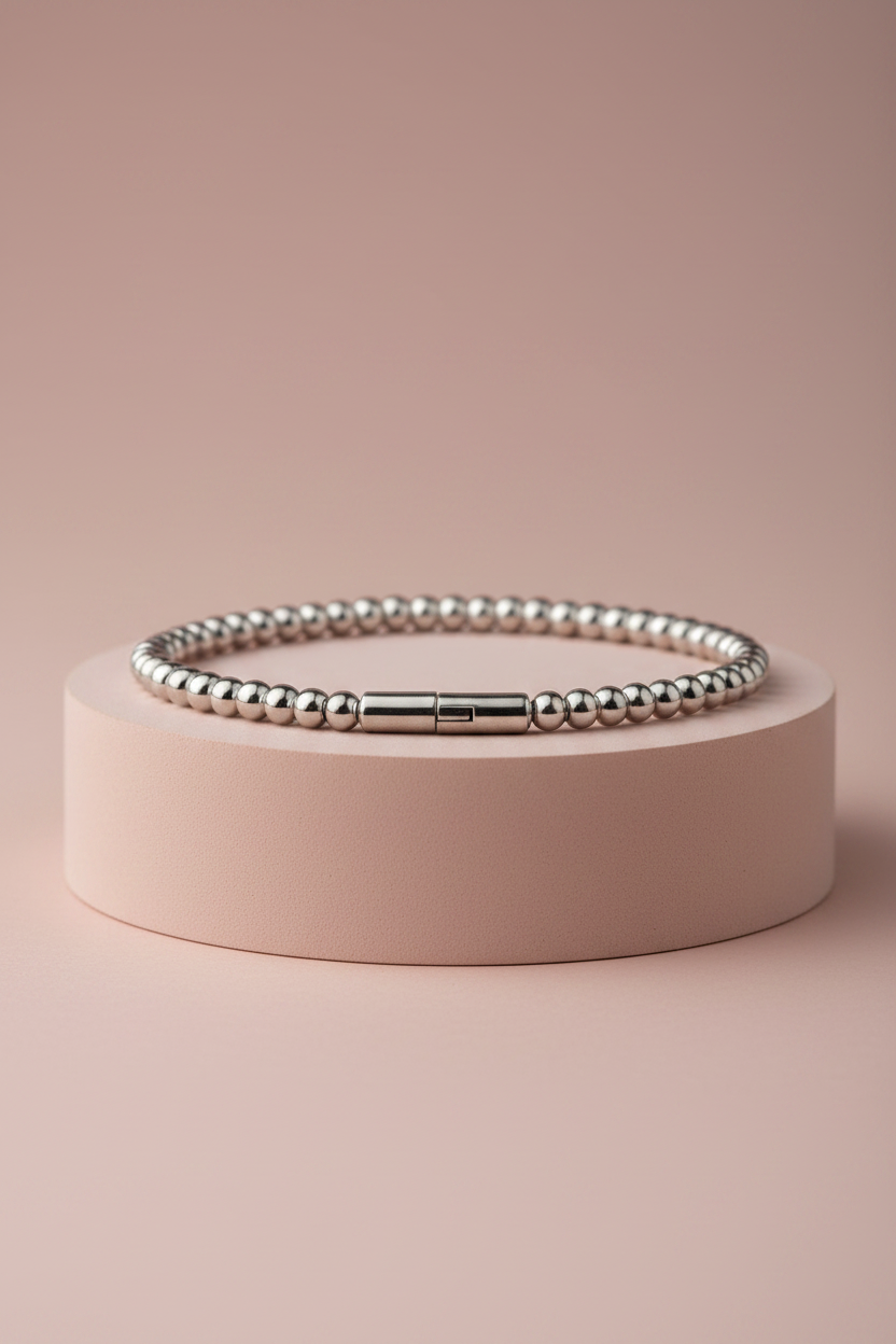 Lamù bracciale rigido apribile piccole sfere acciaio inox su piedistallo rosa cipria